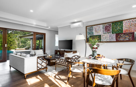 Living and dining area of villa with l shaped lounge and flat screen tv