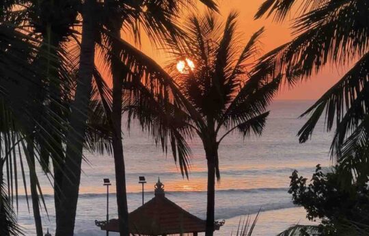 Is it worth visiting Legian, Bali? Legian beach bali at sunset with palm trees
