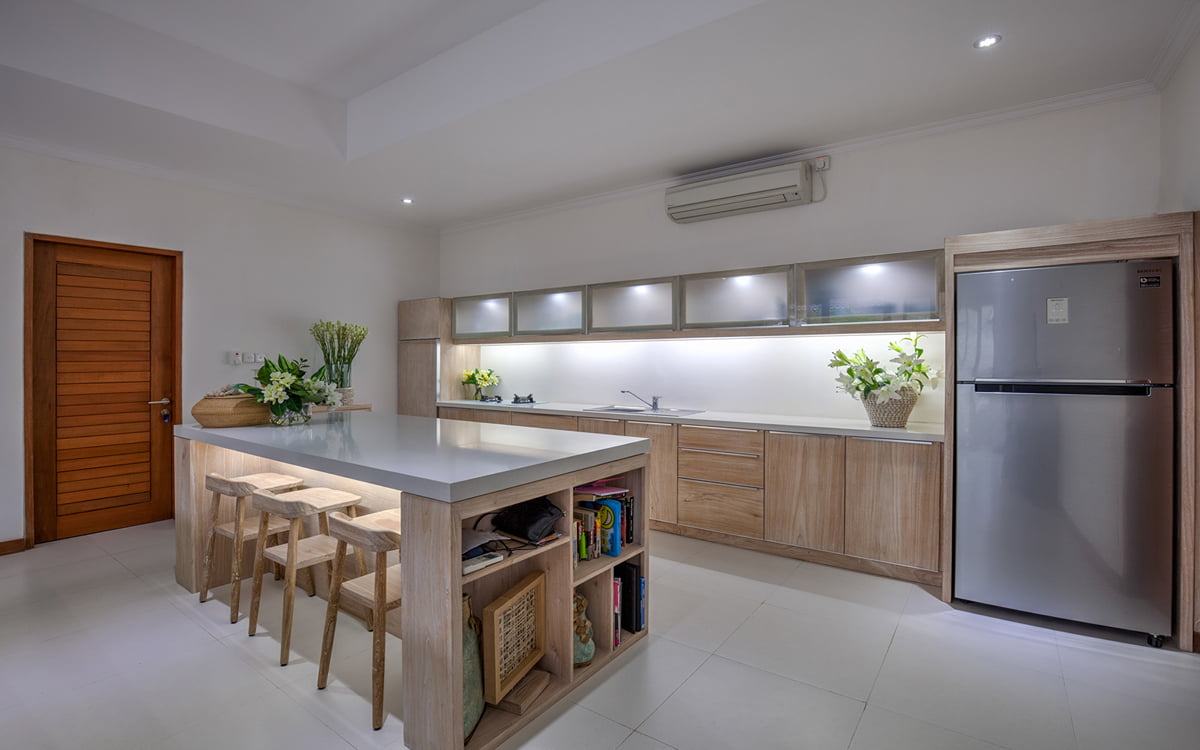 Kitchen of villa with island bench and three stools