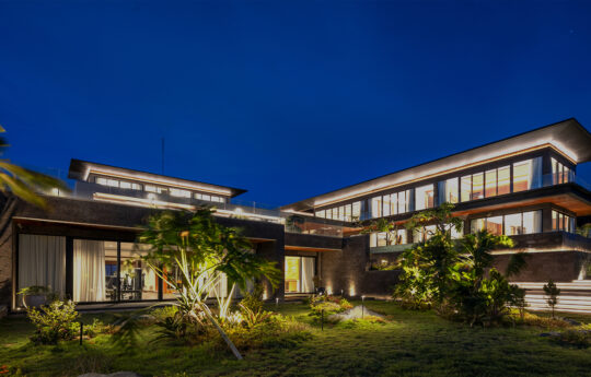 Night time views of exterior Villa Bie with lights on