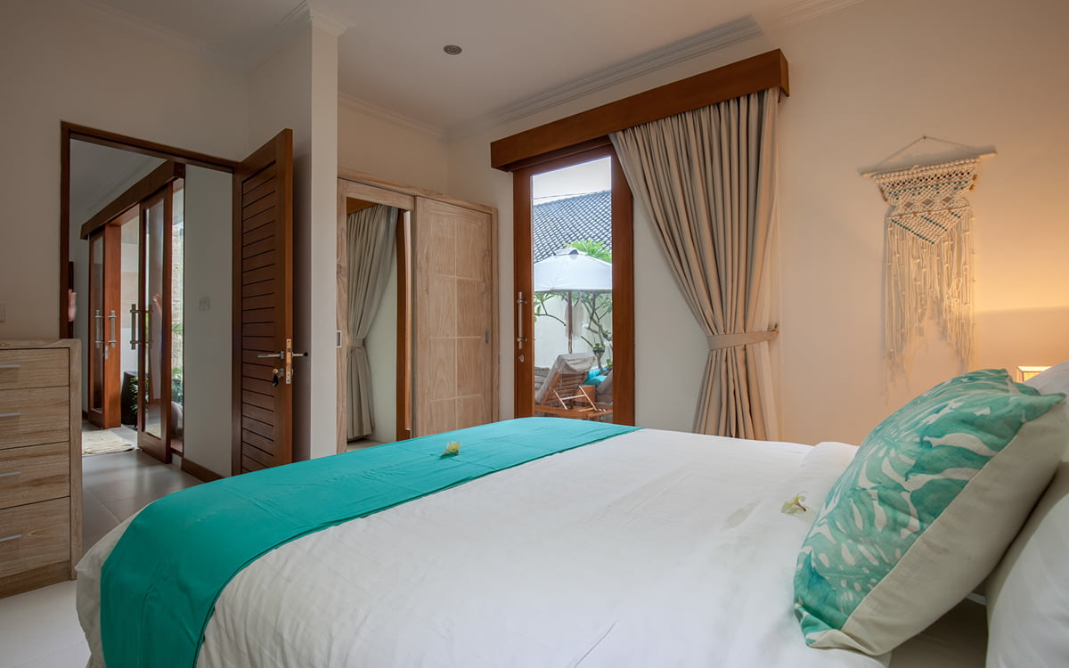 Bedroom with view to living areas and sliding door with view of garden