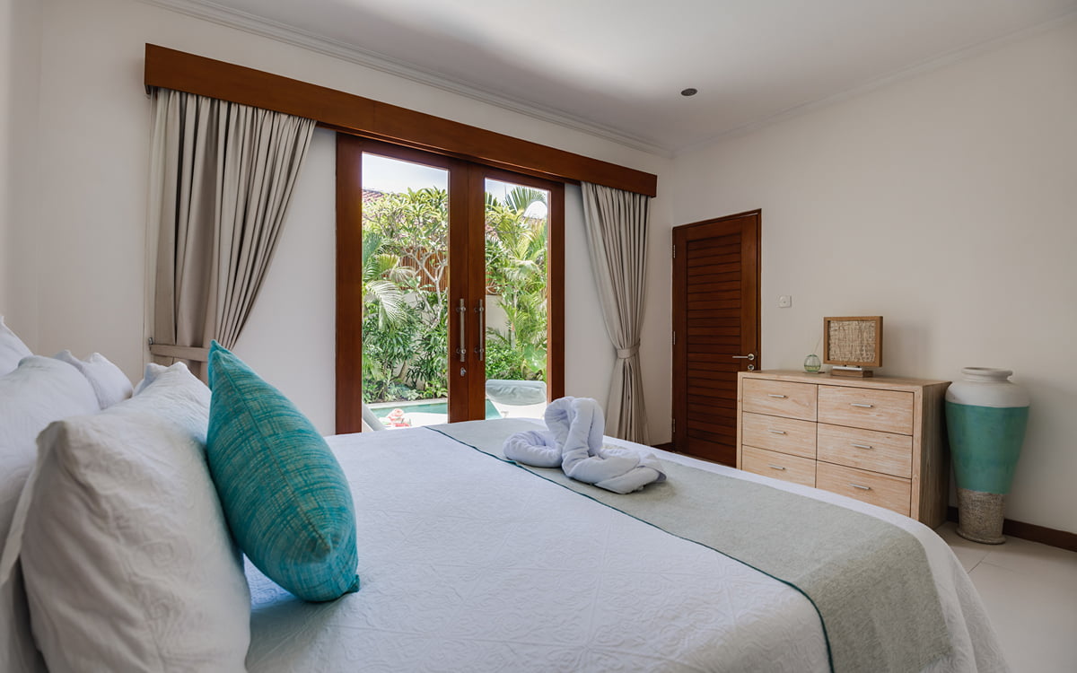 Bedroom of villa with view of garden area