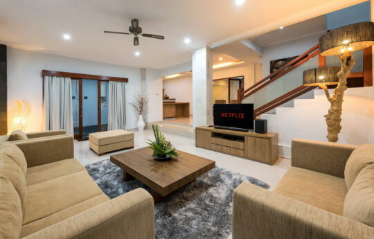 Lounge area of villa with two sofa and flat screen TV with netflix logo