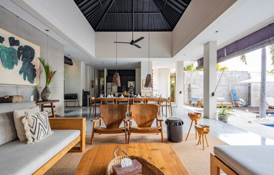 Living areas of villa with dining table and sofa