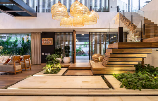 Internal living areas of villa with hanging bamboo lights and staircase