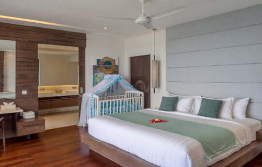 Master bedroom of nusa dua villa with baby cot and en suite bathroom