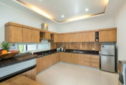 L shaped kitchen with amenities including fridge