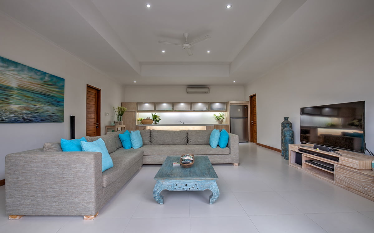 Living room area of villa with sofa and flat screen tv