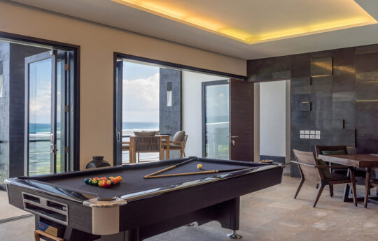 Billiard table of villa with ocean views in games room