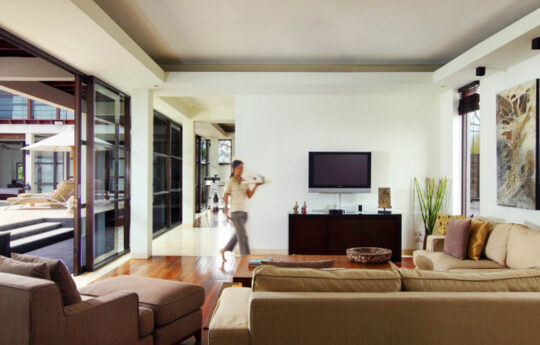Lounge room of villa with TV and bali staff