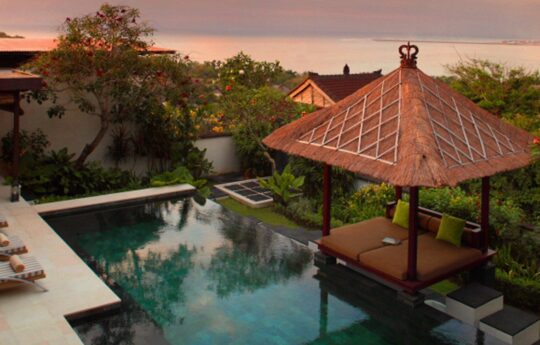 District views at sunset of the Jimbaran area with swimming pool and gazebo in foreground