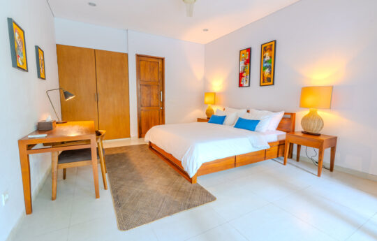 Bedroom with king sized bed and writing desk