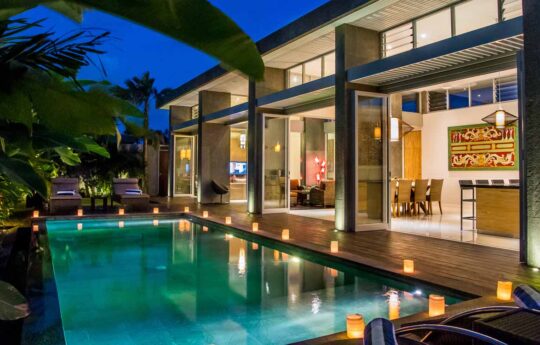 Villa Damai View of swimming pool and villa Damai exterior at night