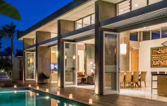 Villa Damai Exterior view of Villa Damai at night with pool lights on