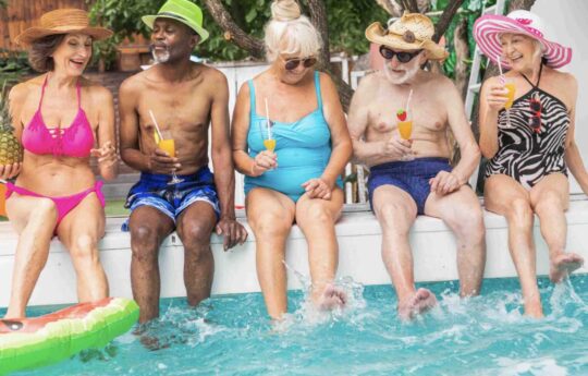 Seniors in their bali villa swimming pool