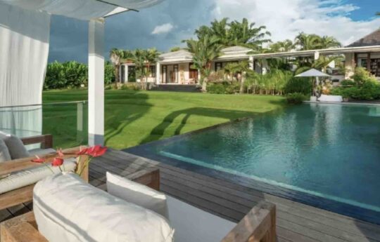 view of swimming pool from gazebo area with villa in background