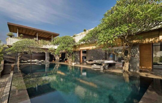 large bali villa with swimming pool views on sunny day