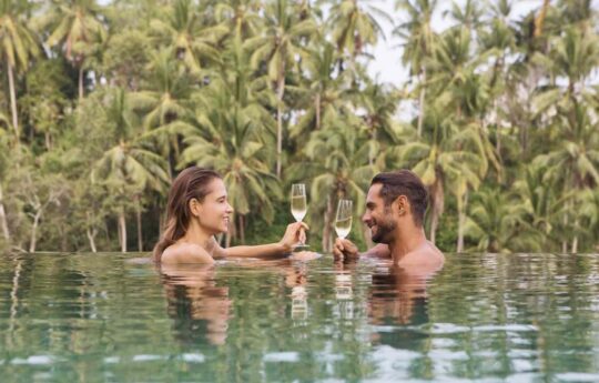 young couple on honeymoon in their private bali villa pool
