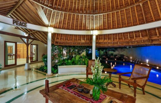 Open plan bali style living areas with view of pool