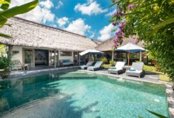 Book Villa Damai Manis - contact Bali Villa Escapes Sunny pool views of Villa Damai Manis with day beds and alang alang roof