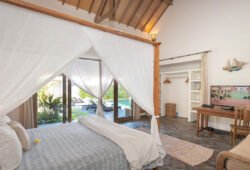 Book Villa Damai Manis - contact Bali Villa Escapes Modern bedroom in villa with TV and views of pool
