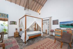 Book Villa Damai Manis - contact Bali Villa Escapes Modern bedroom with high ceiling and king size bed with mosquito net