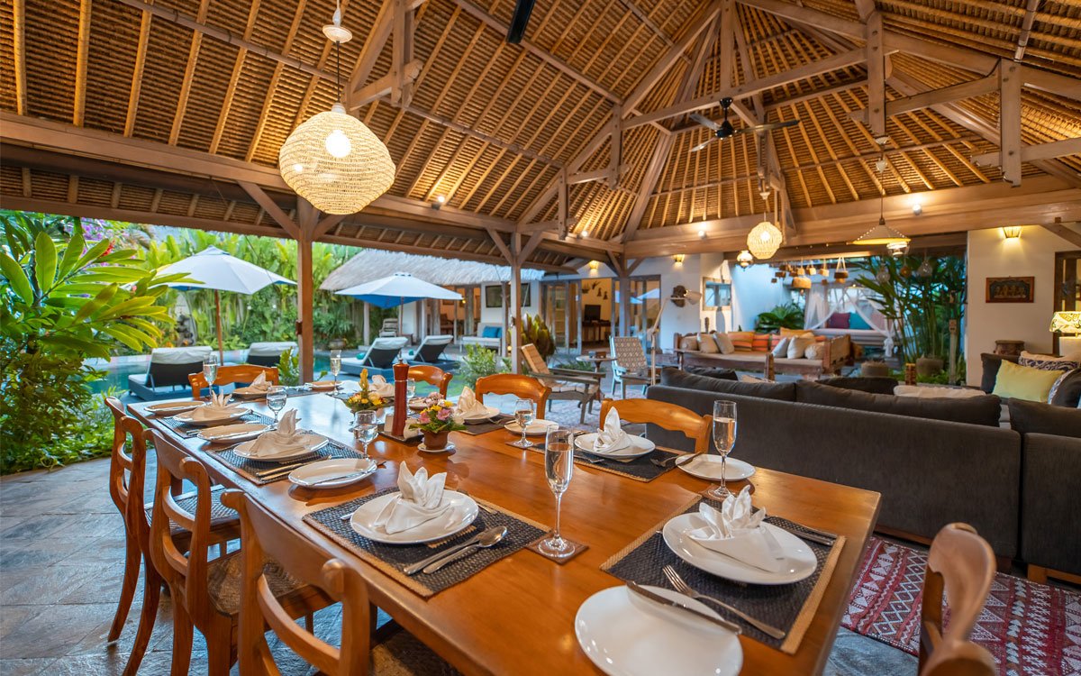Living and dining areas of villas with garden in background