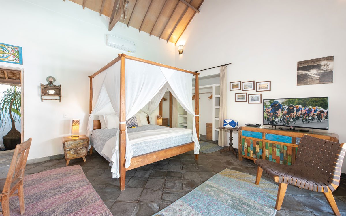 Lovely comfortable bedroom with artwork on walls and bed