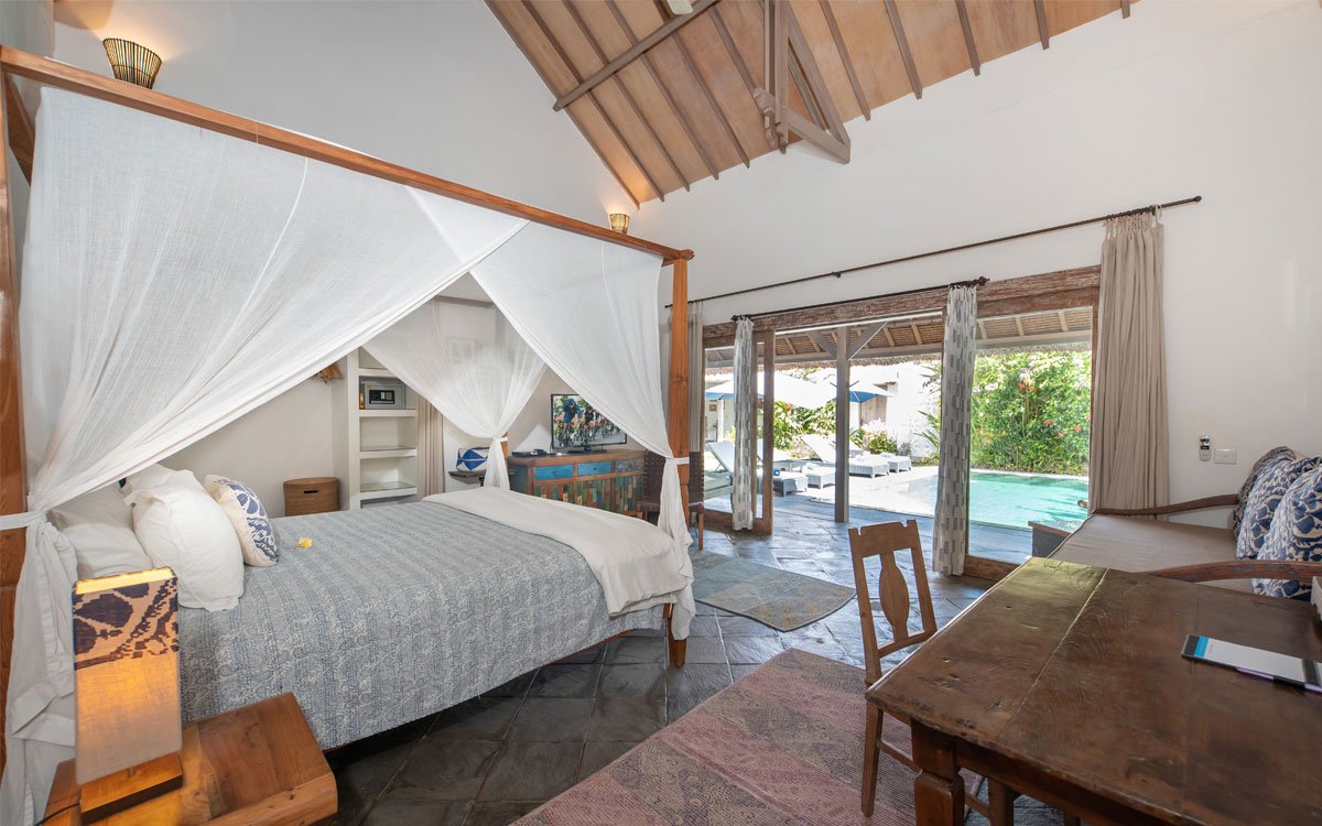 Modern bedroom with bed and views of swimming pool and garden