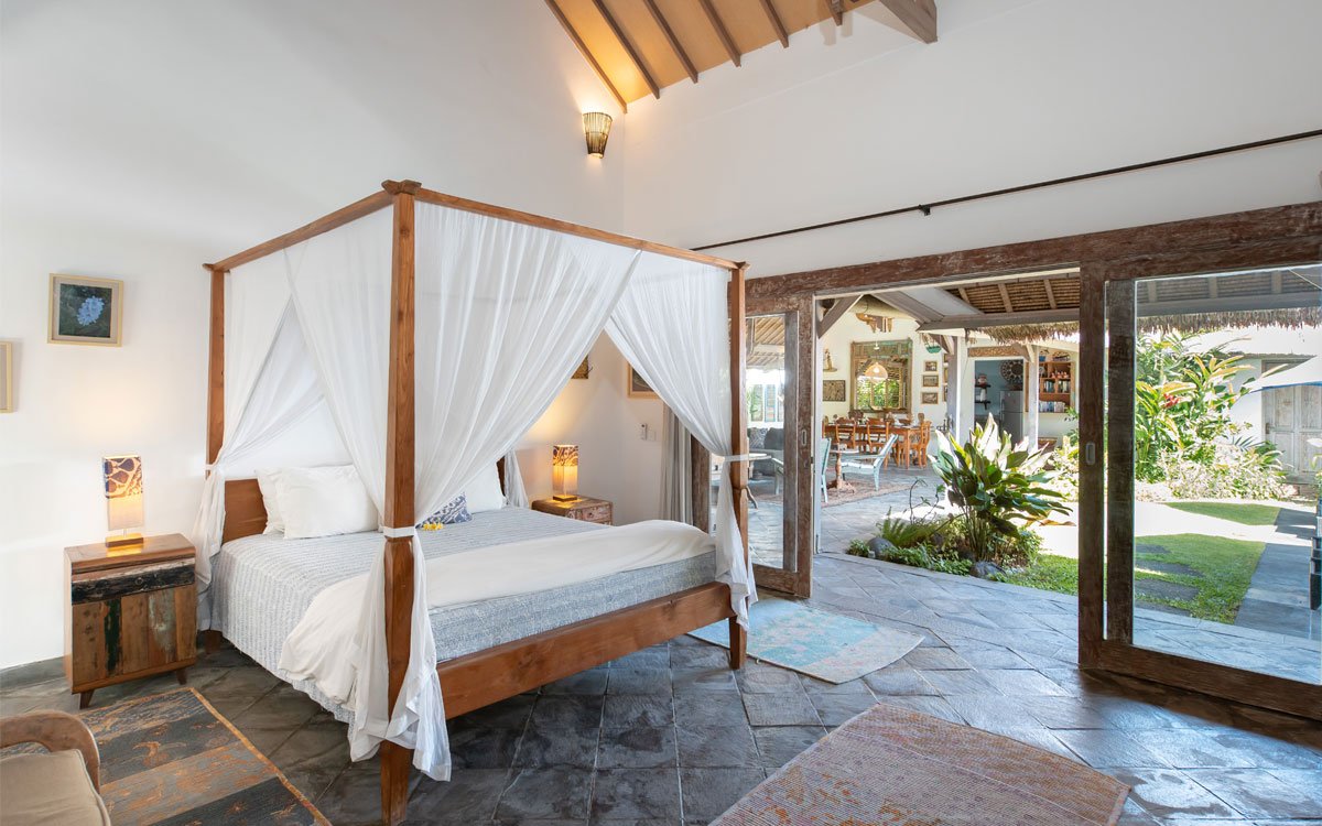 Modern bedroom with queen bed and views of garden