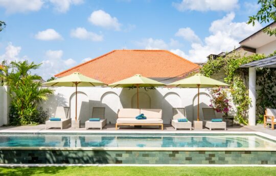Swimming pool views with five day beds in background