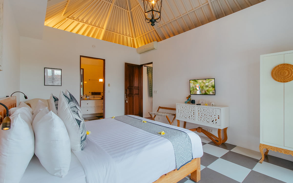 Modern bedroom in villa with ensuite bathroom