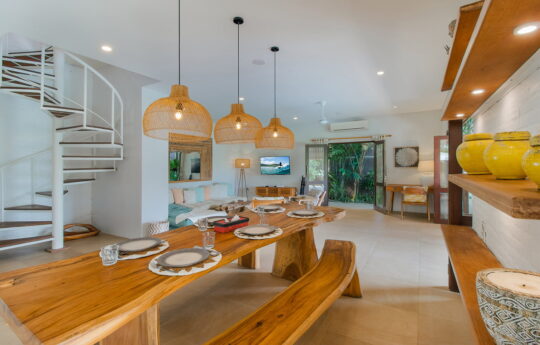 Dining table and kitchen area of villa