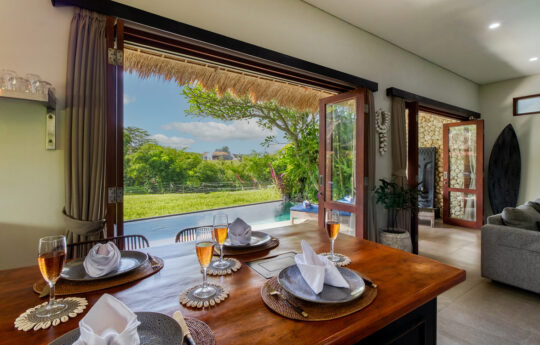 Dining table of villa for six people with view to rice fields