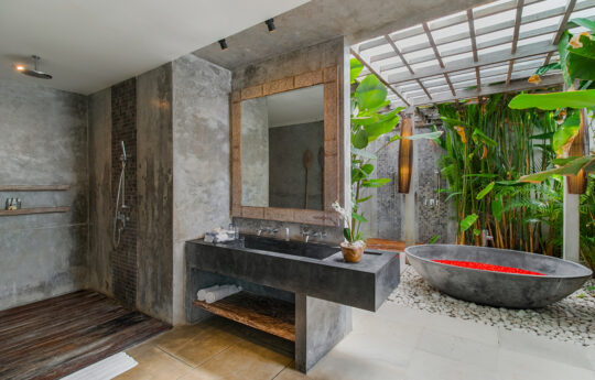 bathroom with outdoor bathtub and rain shoer