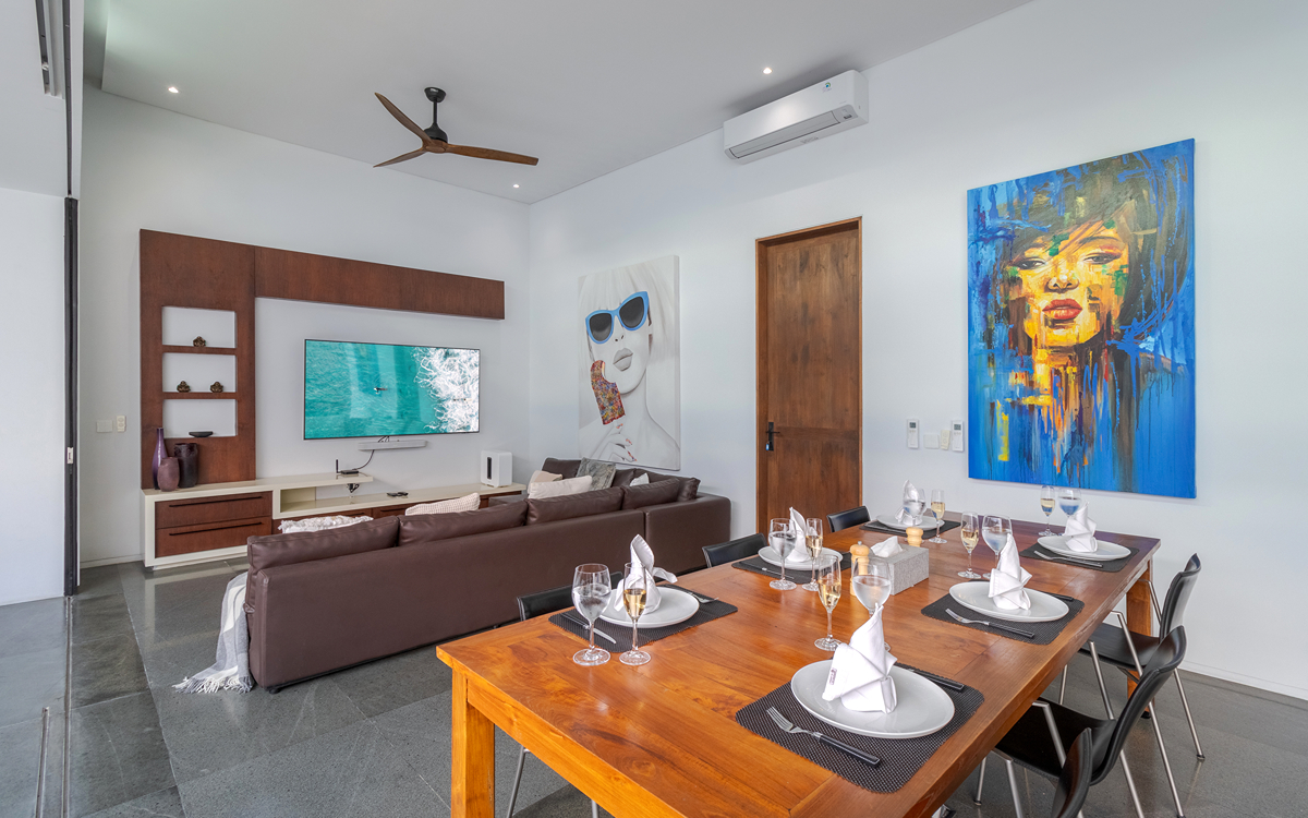 Dining table for 8 people with l shaped sofa and smart tv of villa