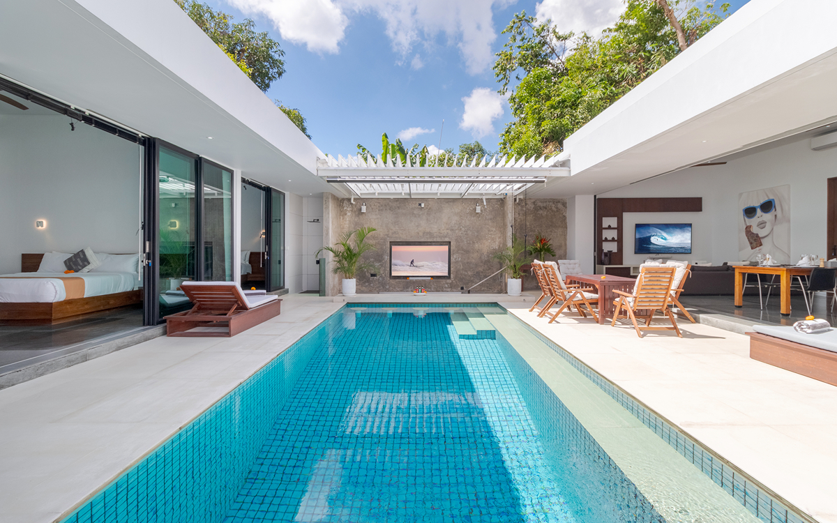 sunny swimming pool and villa exteriors