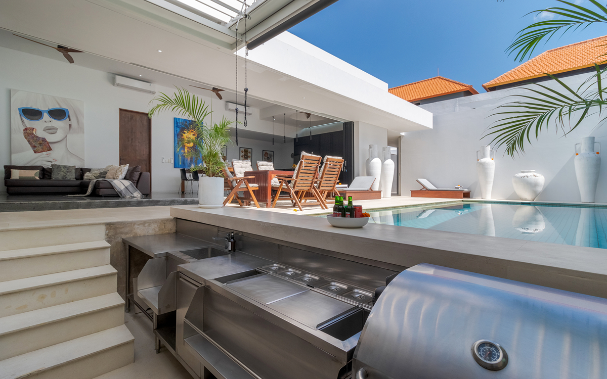 BBQ area of villa with pool and villa exteriors and views to living room