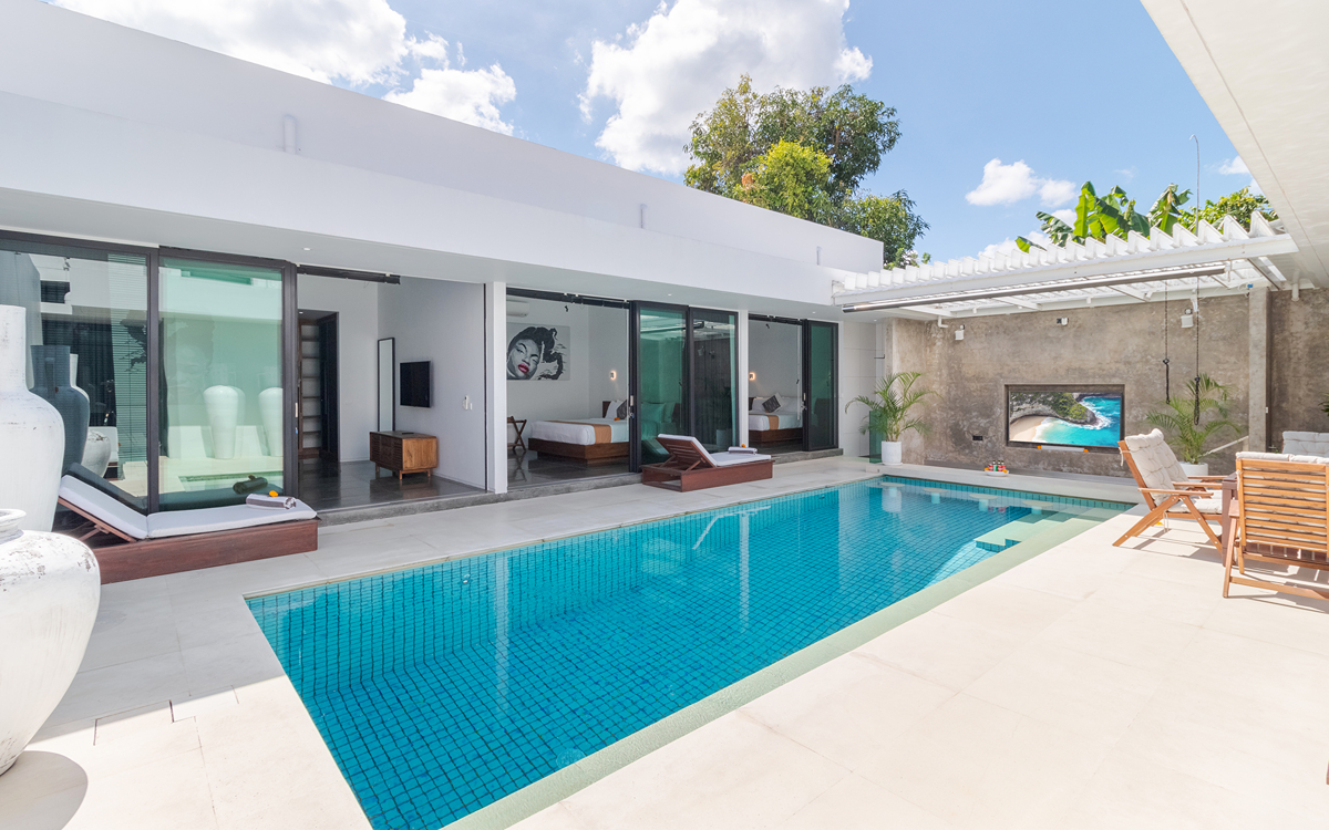 Lovely swimming pool and deck area of villa with views to bedrooms