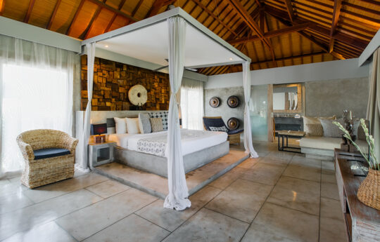 four poster bed with mosquito netting and view of entire room
