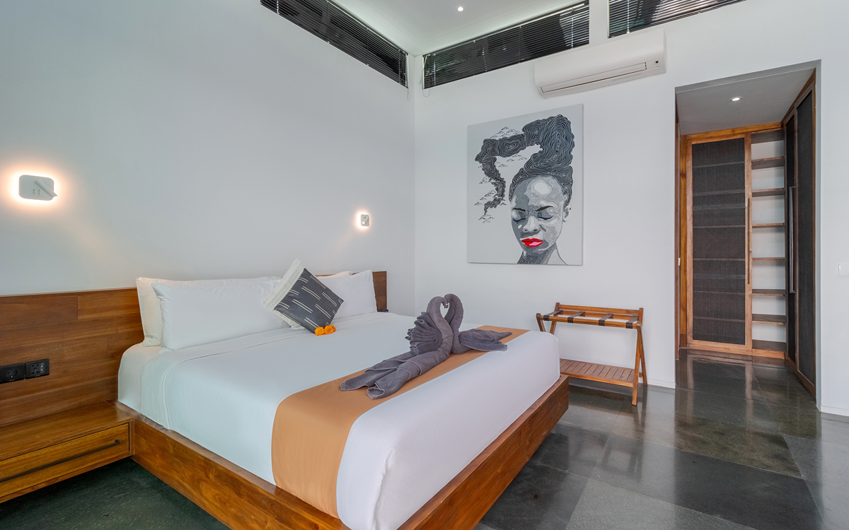 modern large bedroom of villa with king bed and en suite entrance