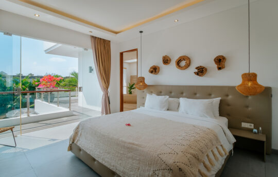 Modern bedroom of villa with king bed with views of outside