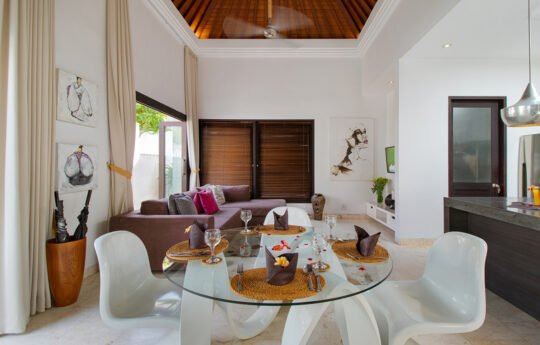 Dining and living areas of villa Lanai with kitchen in background