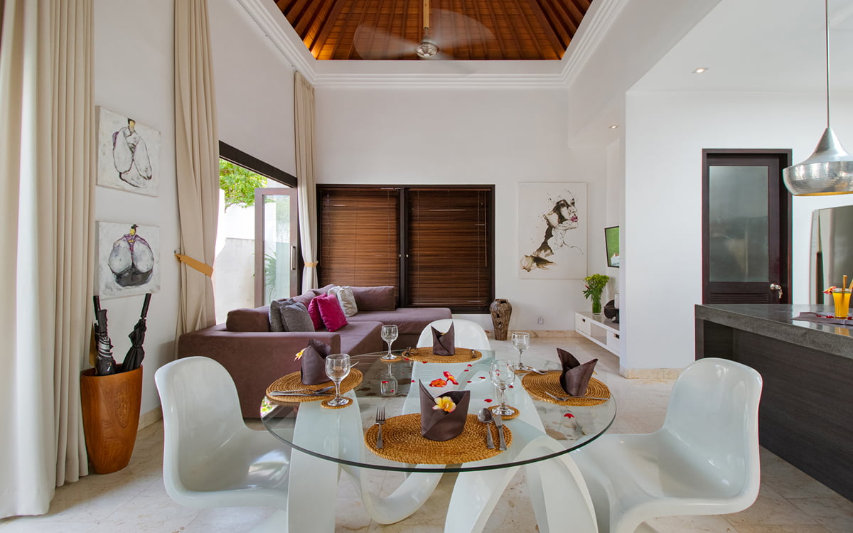 Dining and living areas of villa Lanai with kitchen in background
