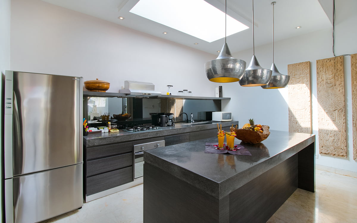 Modern kitchen of villa with island bench and cooking area
