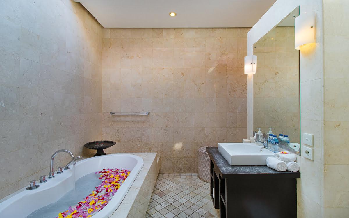 Bathtub in ensuite bathroom of villa with vanity