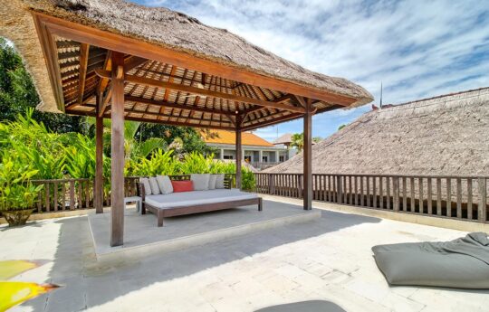 Outdoor cabana area with day bed on sunny day