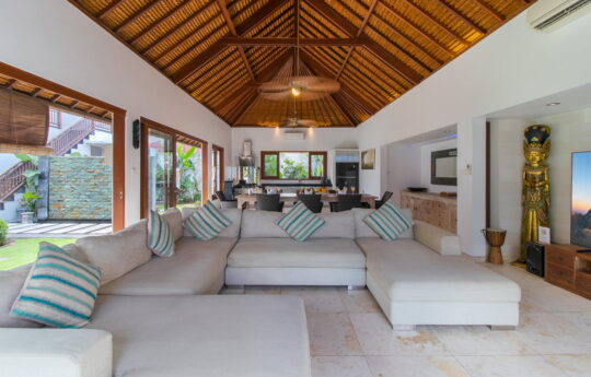 Open plan living and dining room areas of villa with big sofa