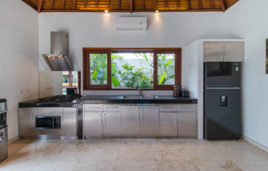 Modern kitchen of villa with fridge and sink