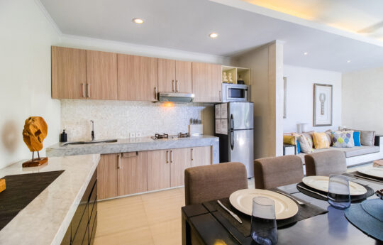 Modern kitchen with fridge and dining table